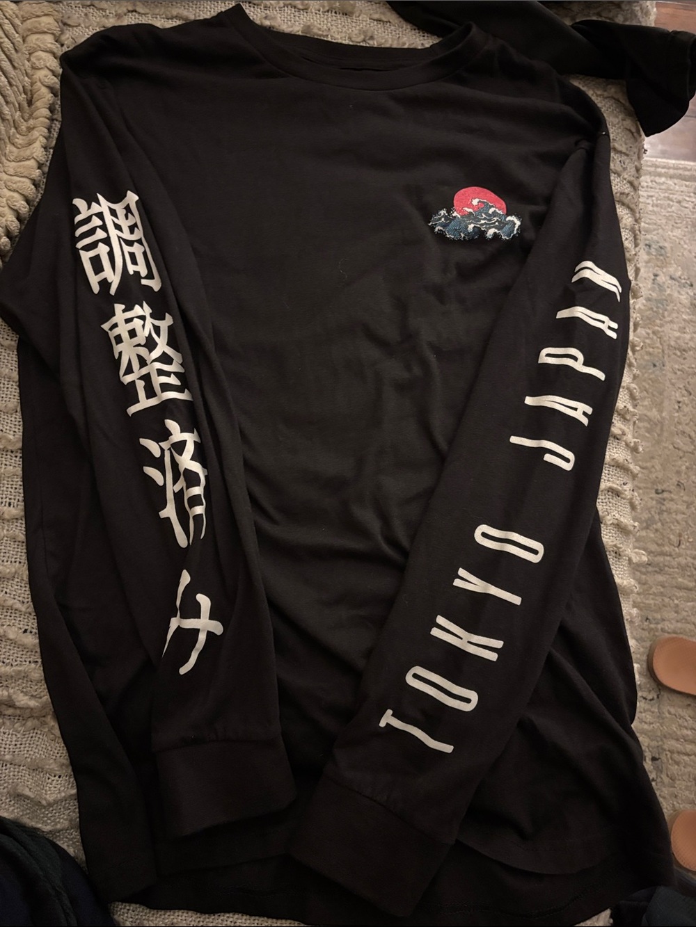 Nui Black Long Sleeve Tee with White Sleeve Script and Red Wave Accent